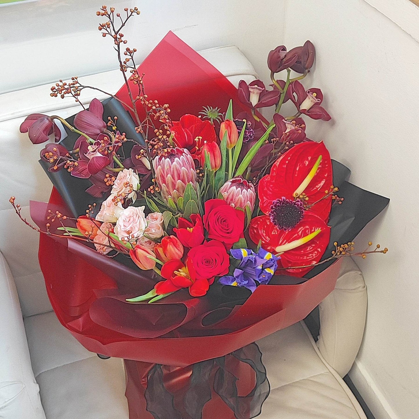 Deep red cymbidium red tulip anthurium Alice small rose amaryllis red rose protea mountain return bouquet -- – F-539 - party X party
