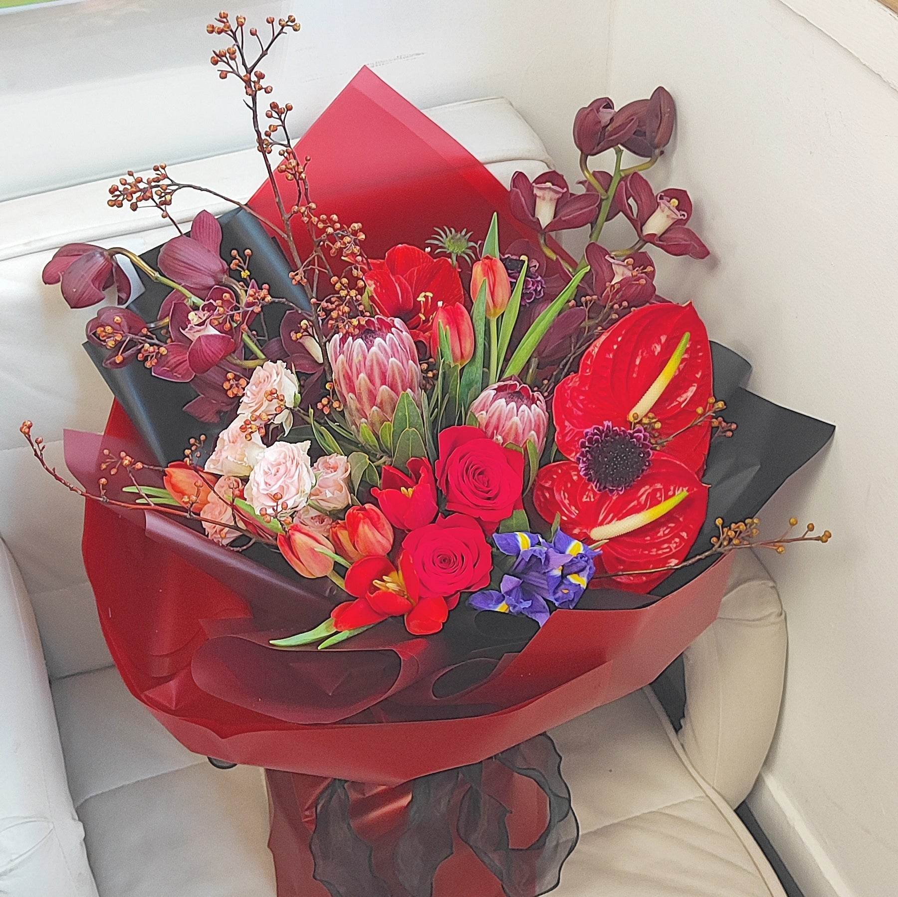 Deep red cymbidium red tulip anthurium Alice small rose amaryllis red rose protea mountain return bouquet -- – F-539 - party X party